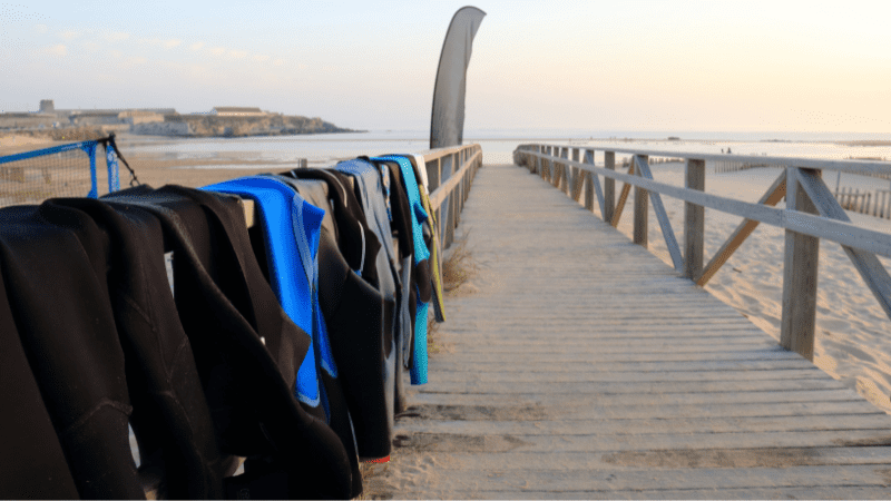 Neoprene costumes hanging on the wooden path