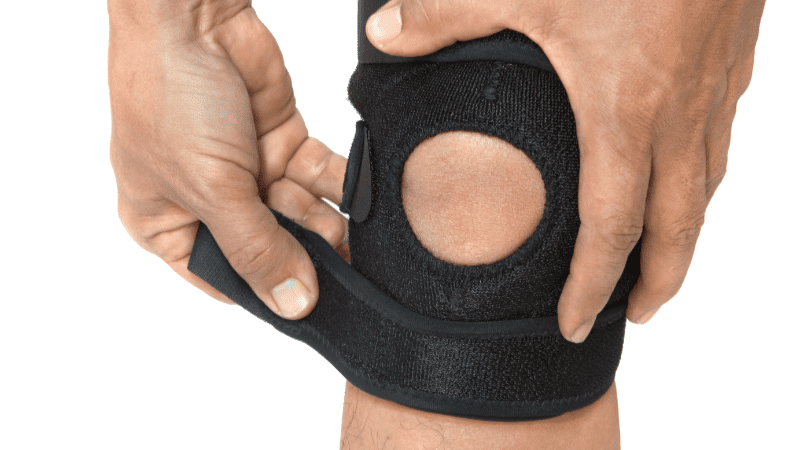 man's leg in a protective rubber knee brace