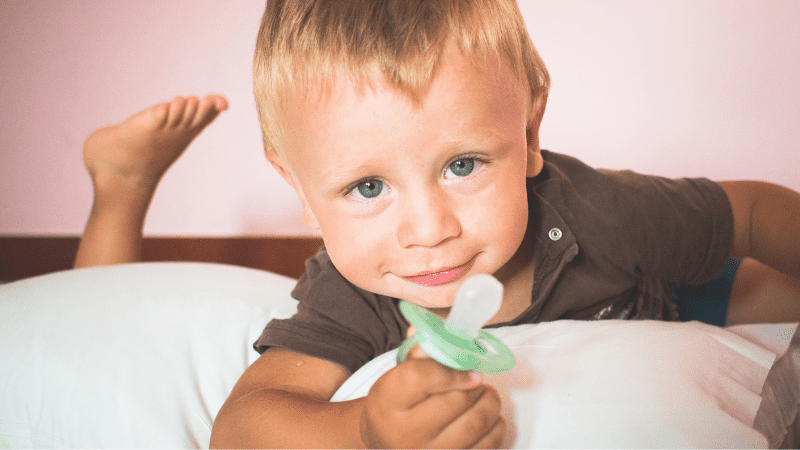 A child holds his favorite pacifier