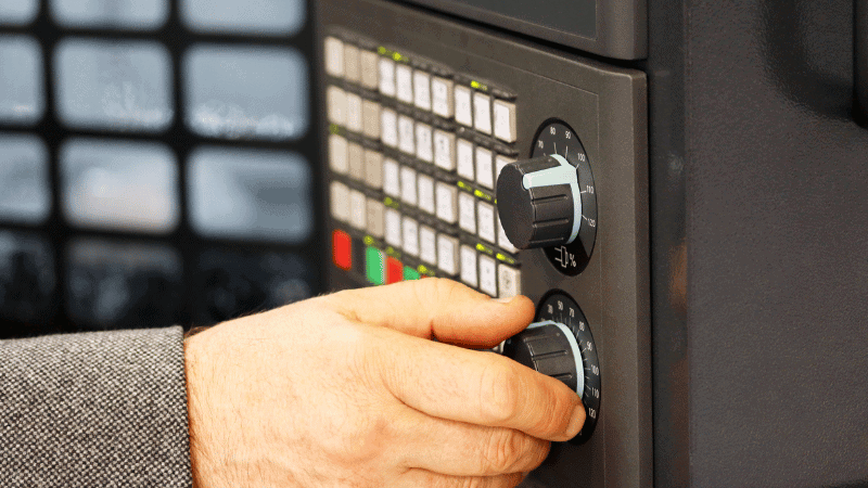 A man is monitoring quality controlling process parameters.