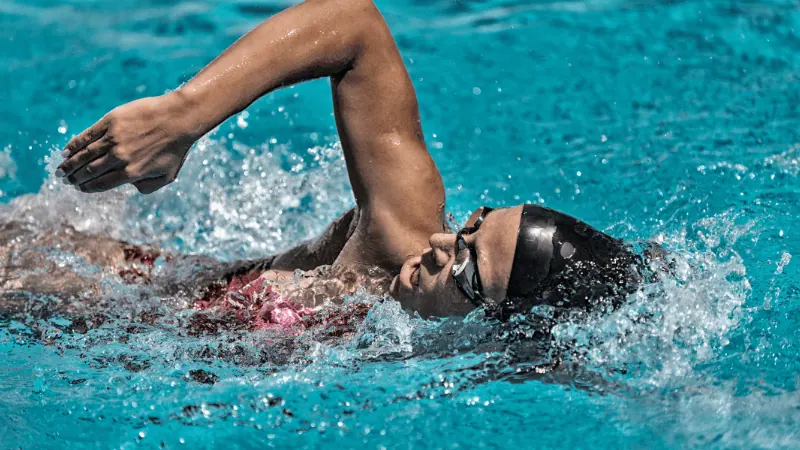 A woman wearing a swim cap